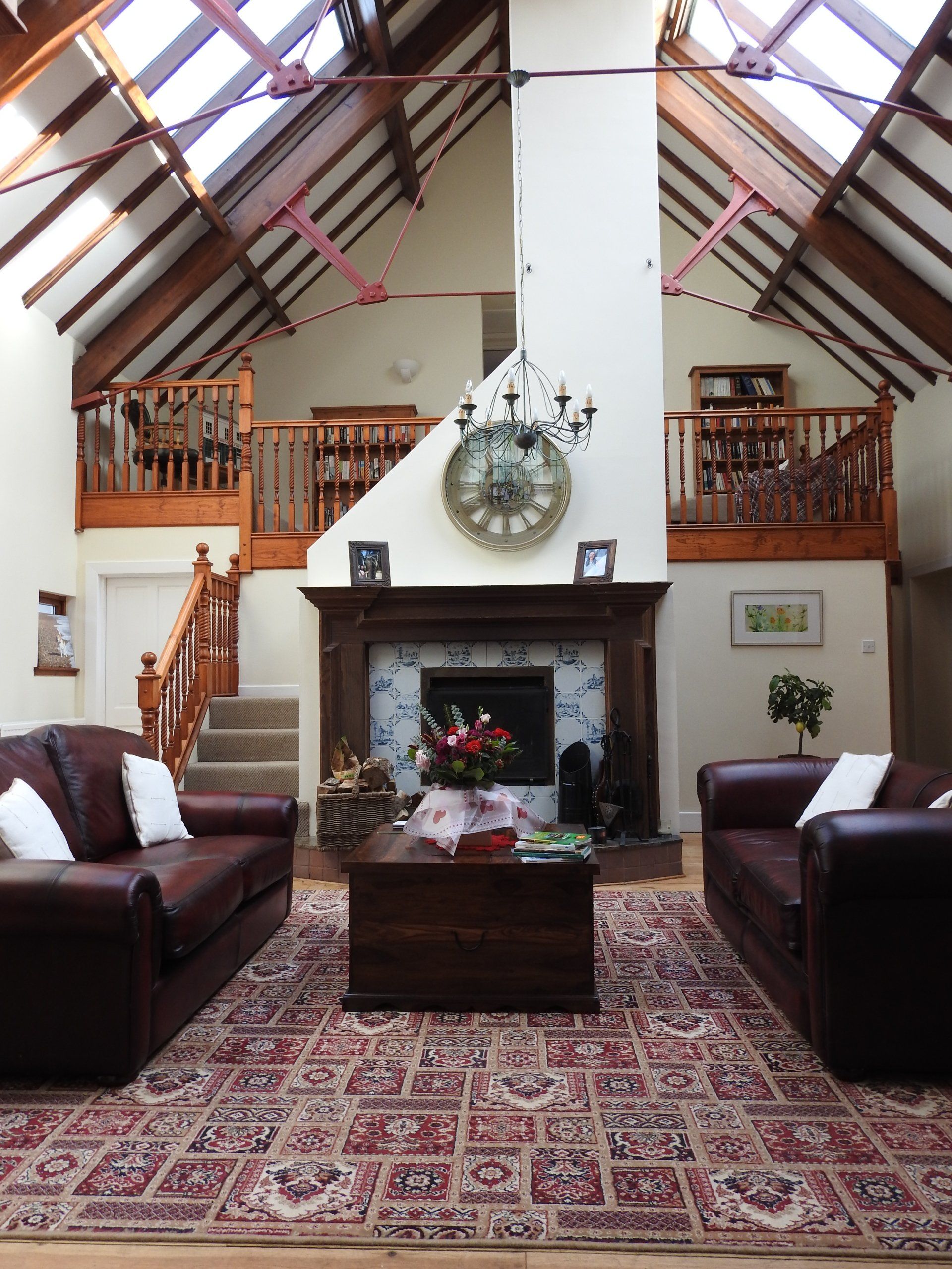 Double-height lounge with original beams and fireplace